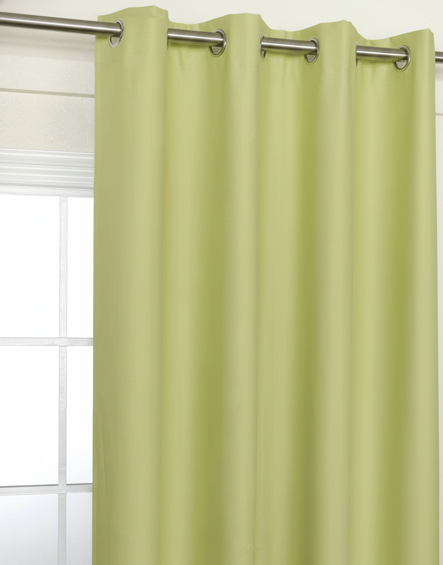 Lime Green curtains hanging on a rod with a window in the background.