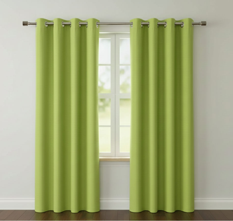 Green curtains with grommets on a window in a room with a neutral color scheme.