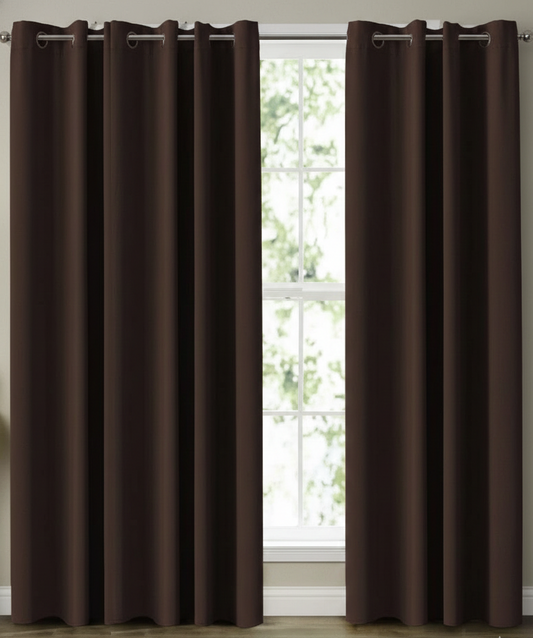 Brown curtains with grommets in front of a window with white trim.
